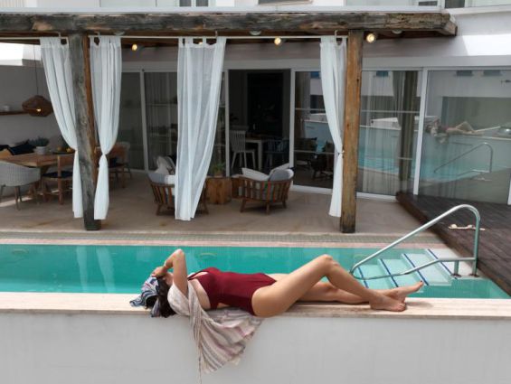 Nausicaa Villas Protaras exterior pool woman sunbathing by the pool