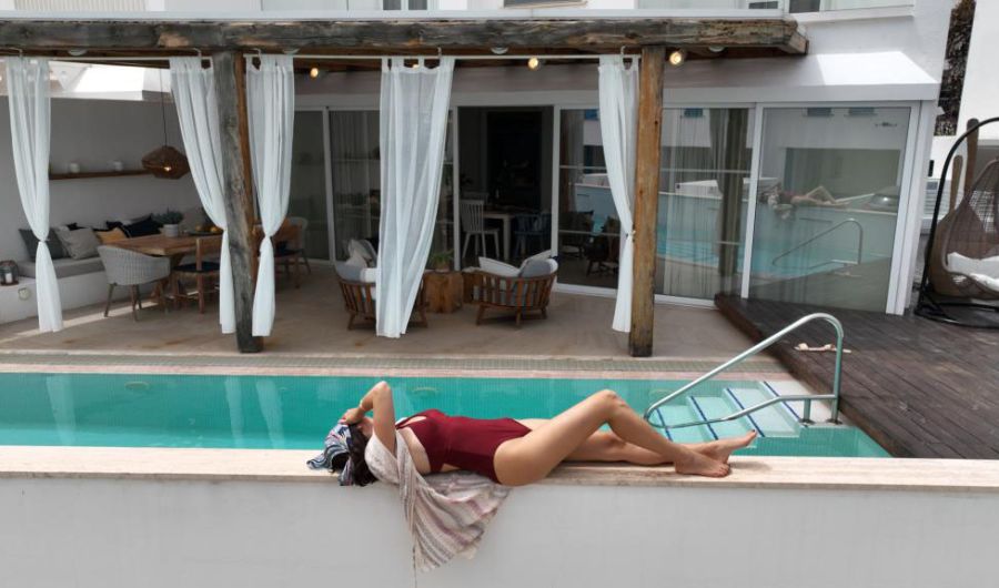 Nausicaa Villas Protaras exterior pool woman sunbathing by the pool