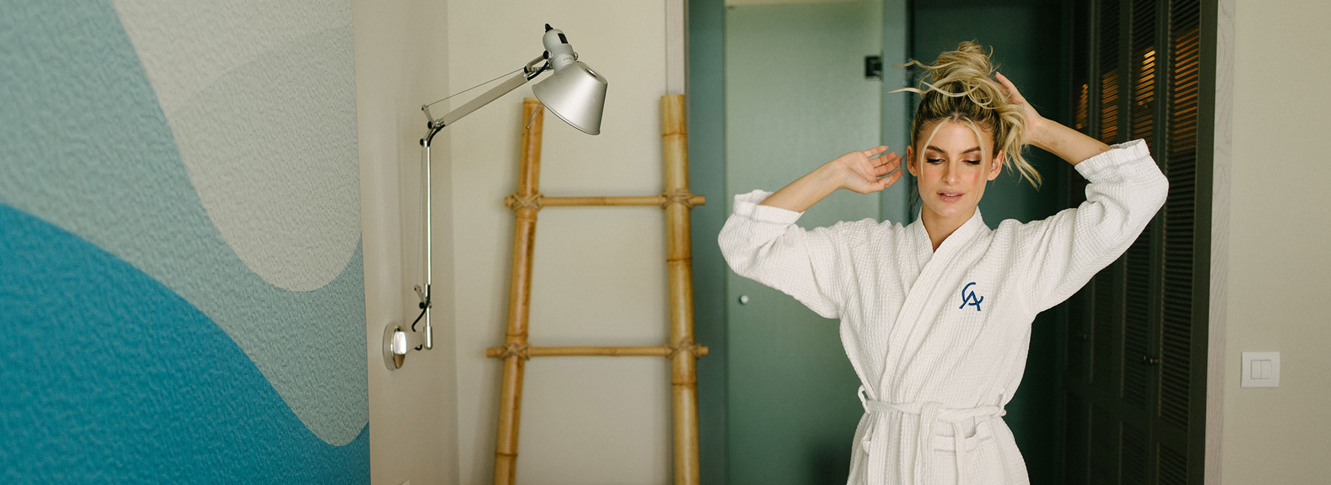 Woman in bathrobe in Amada Villas bedroom