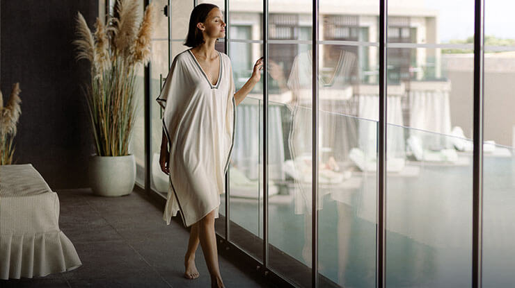 Woman in King Jason Zante hotel looking at the pool view