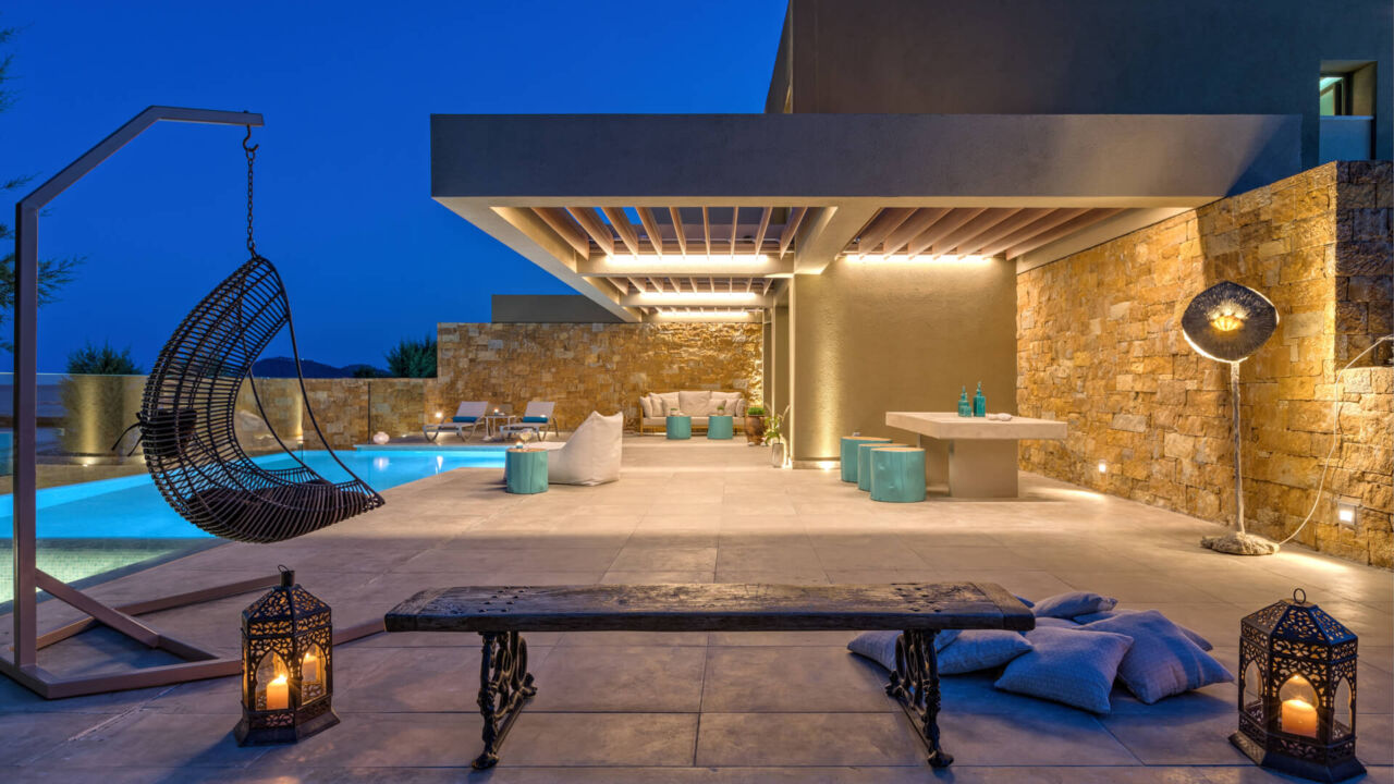 Amada Colossos room terrace with nightlights and pool
