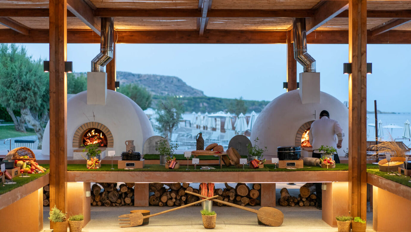 Wooden stoves for pizza and other dishes in open kitchen at Amada Colossos Resort