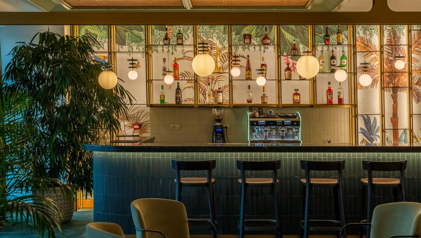 Modern Bar at inside space with plants at Amada Colossos Resort
