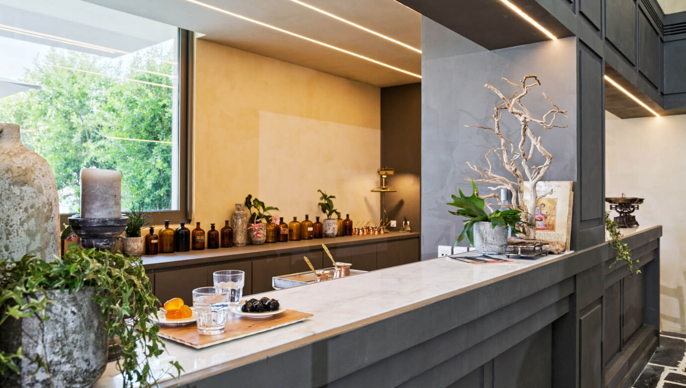 Bar with plant and wooden decorations at Amada Colossos Resort