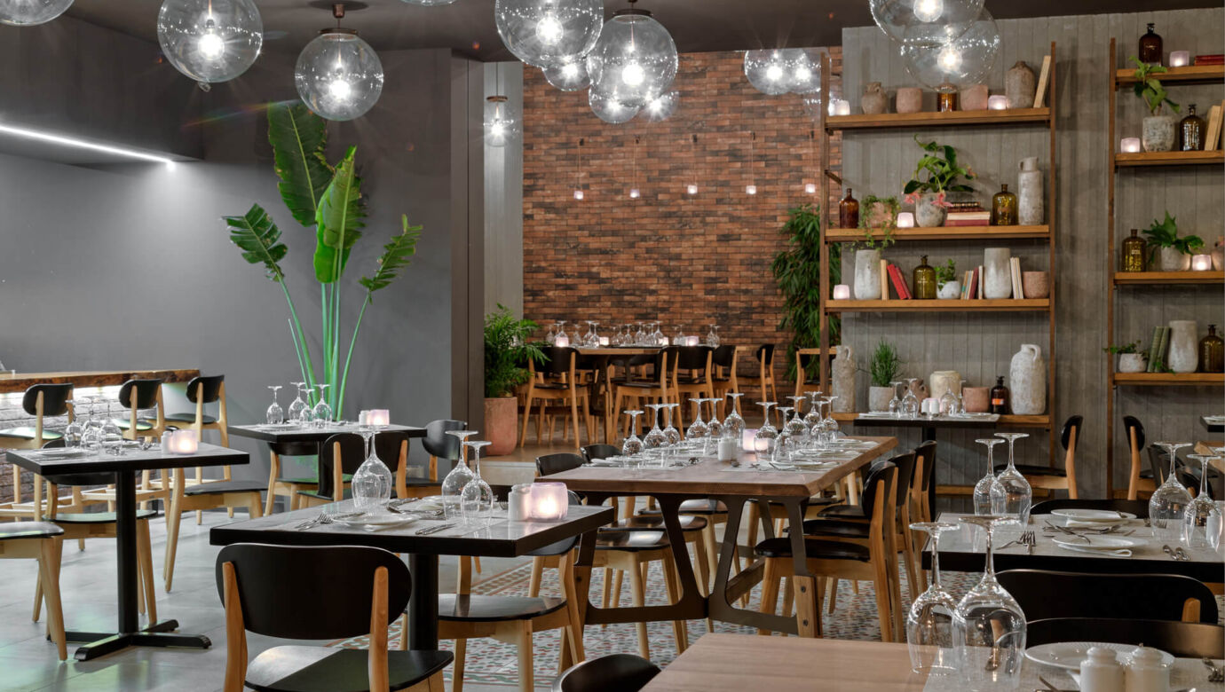 Inside Modern decorations and tables at Amada Colossos Resort restaurant