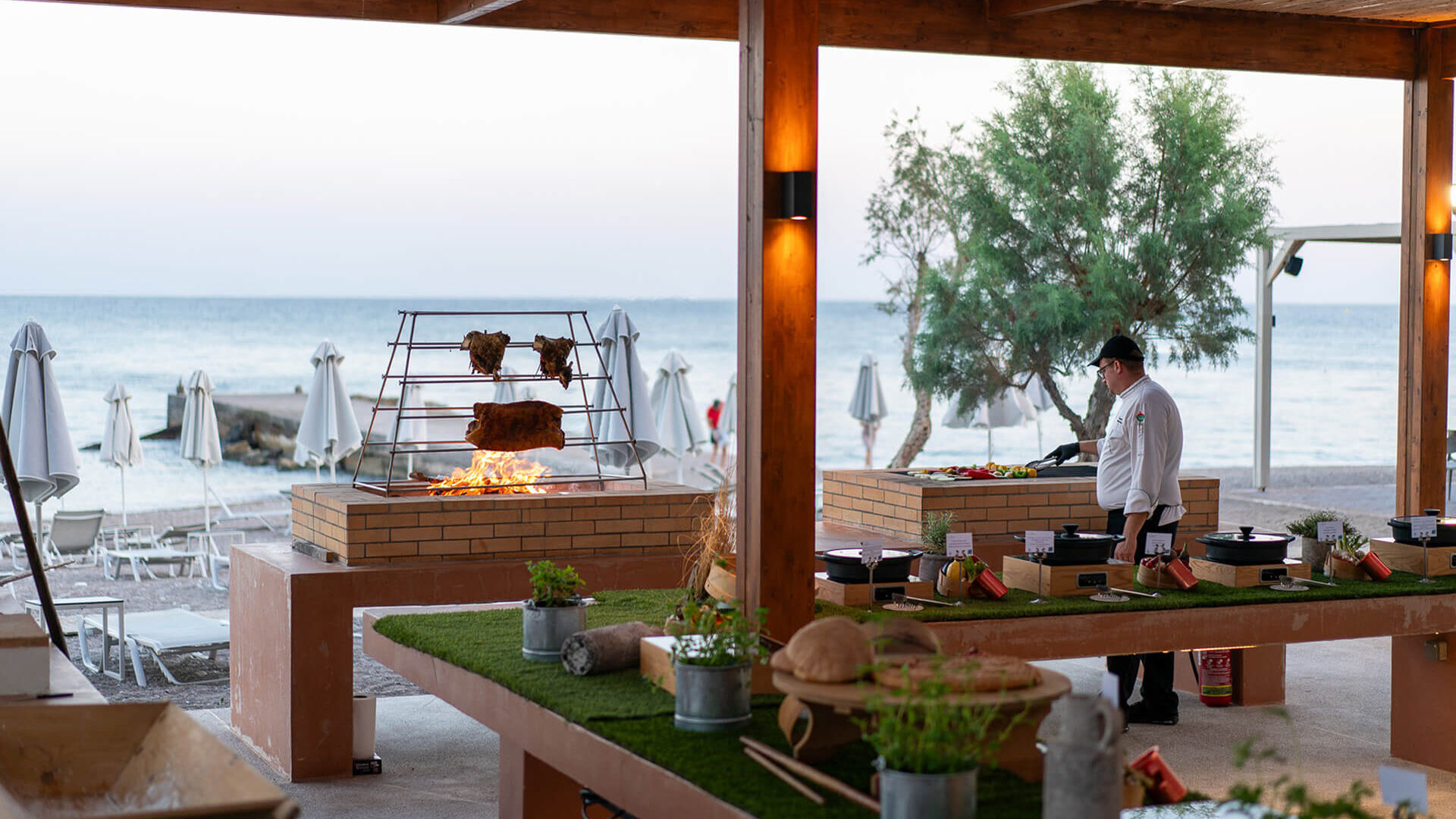 Chef cooking in open kitchen at Amada Colossos Beach side restaurant