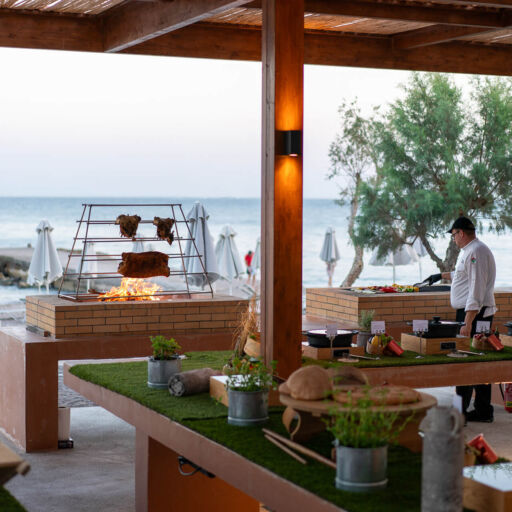 Chef cooking in open kitchen at Amada Colossos Beach side restaurant