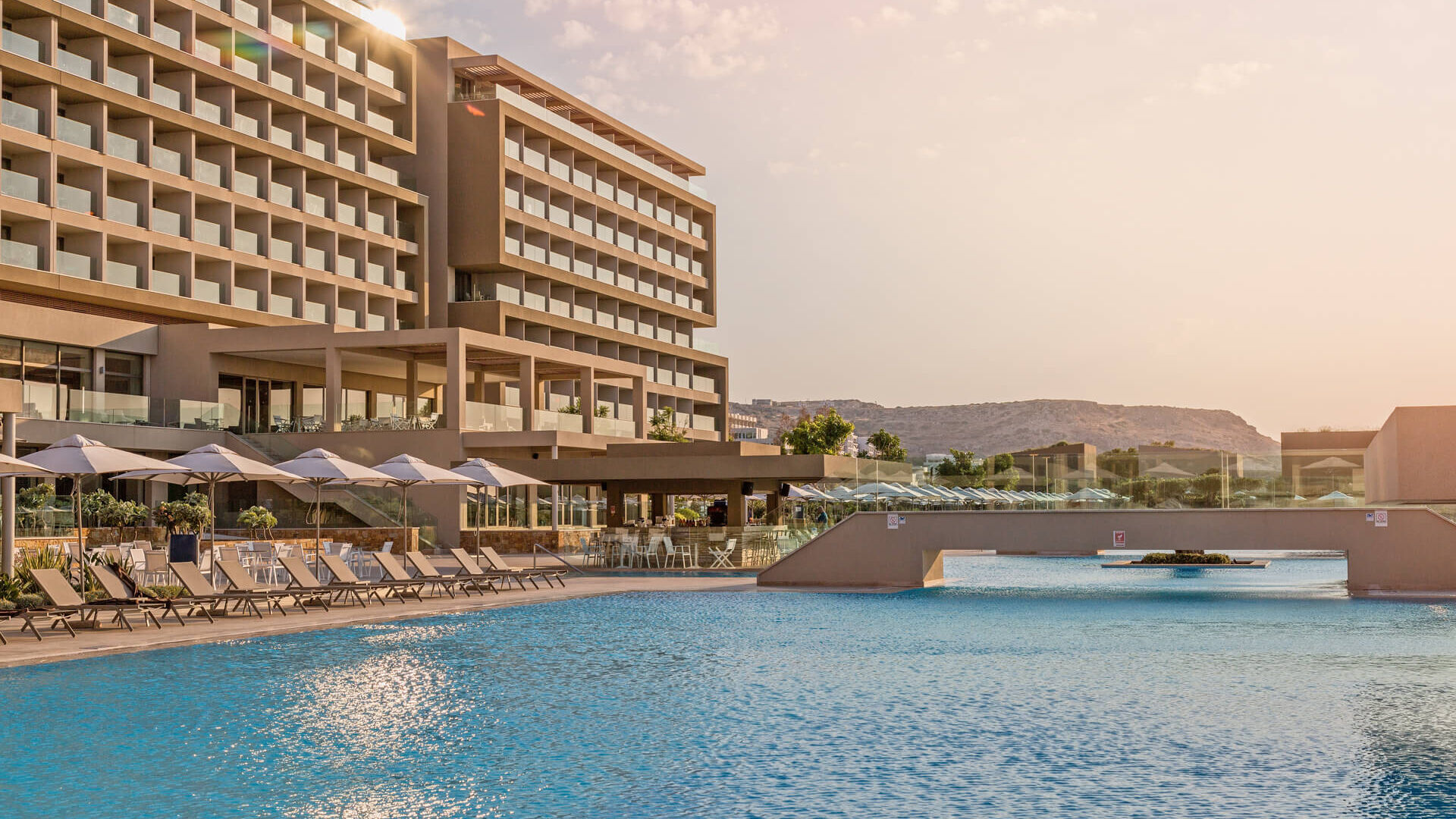 Pool inside Amada Colossos Complex with sunbeds