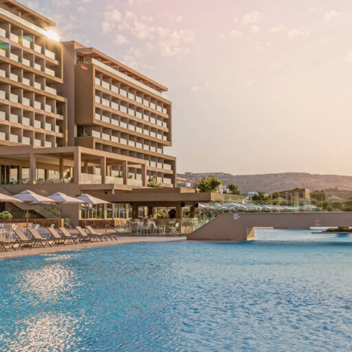 Pool inside Amada Colossos Complex with sunbeds