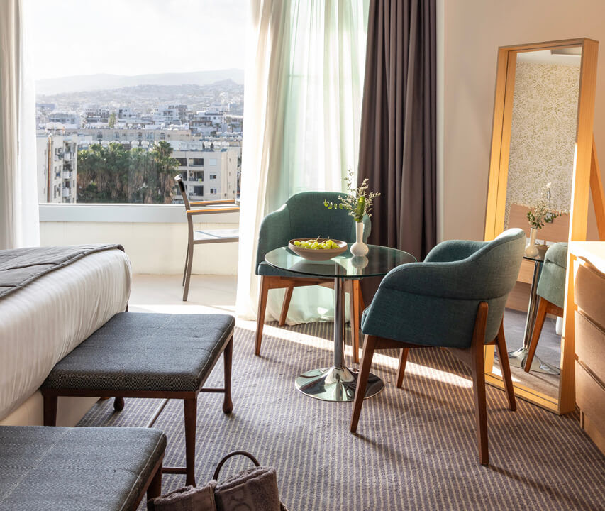 Royal Apollonia Deluxe suite sitting area and balcony