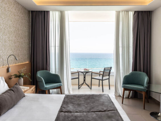 Royal Apollonia Superior Room bedroom with sea view