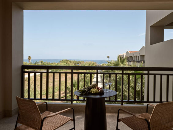 balcony with sea view and a table with fruits at Asterion Suites