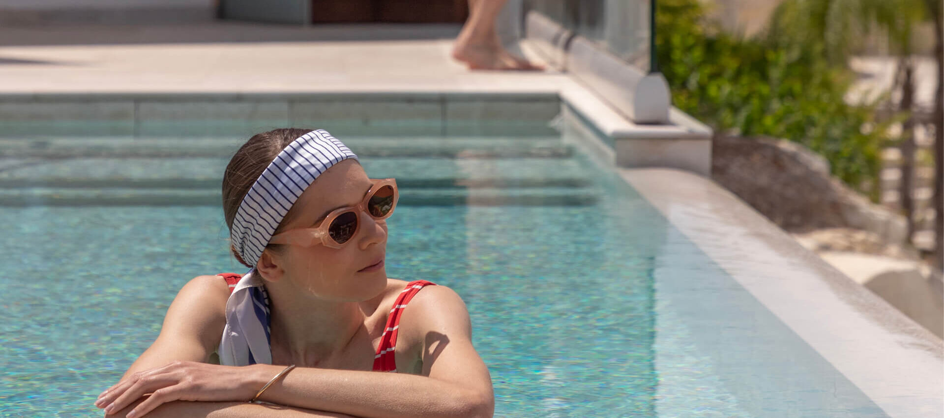 Woman relaxing at St.Elias Suite private pool