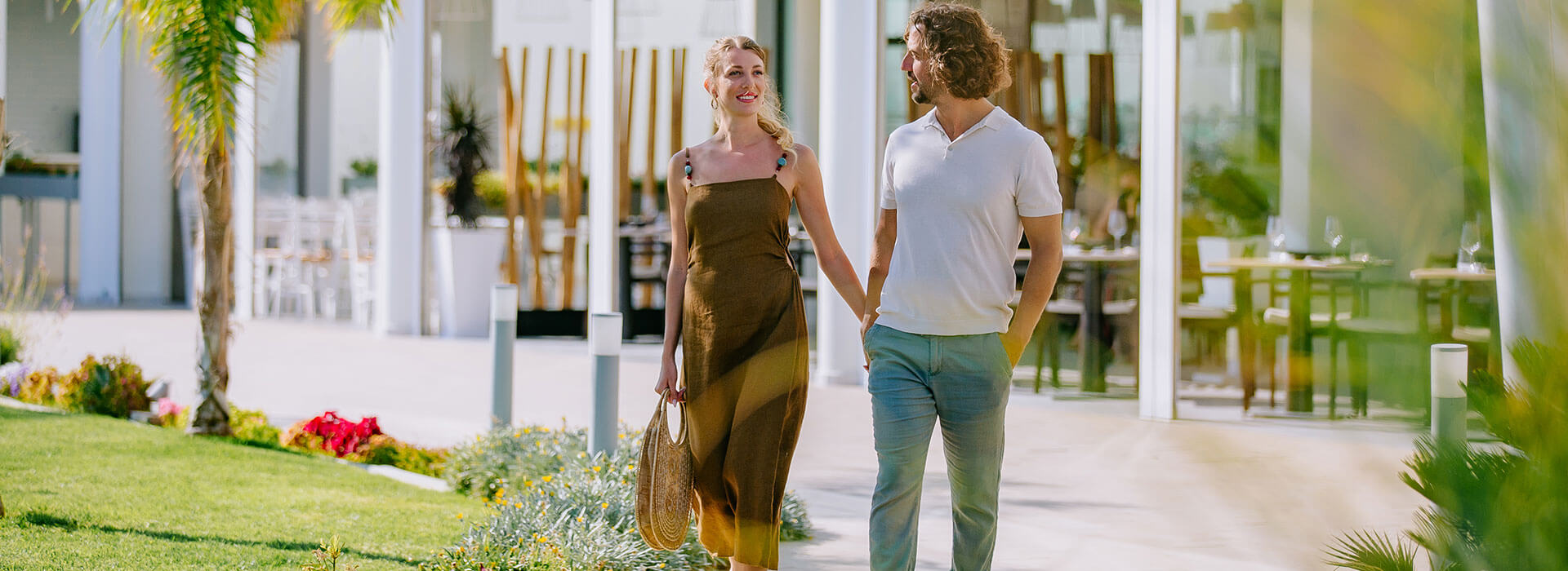 Couple holding hands in Ivi Mare hotel garden
