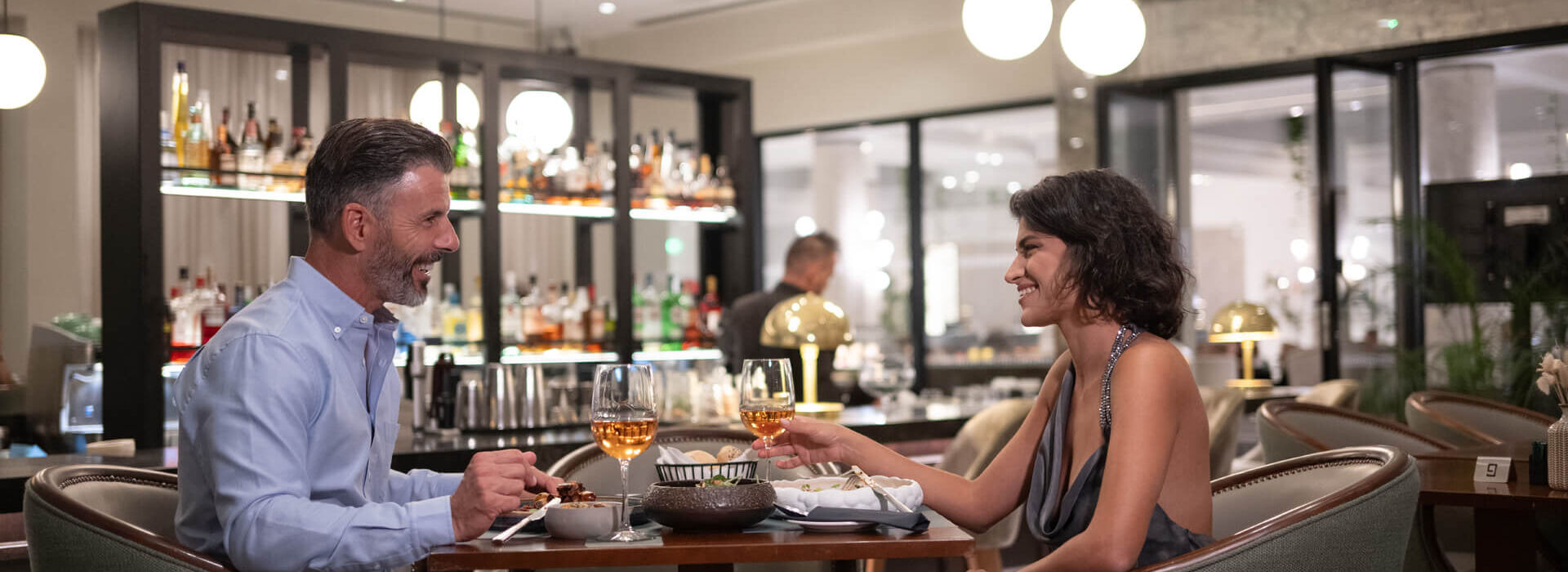 Couple drinking and eating at Hilton Nicosia Indoors bar