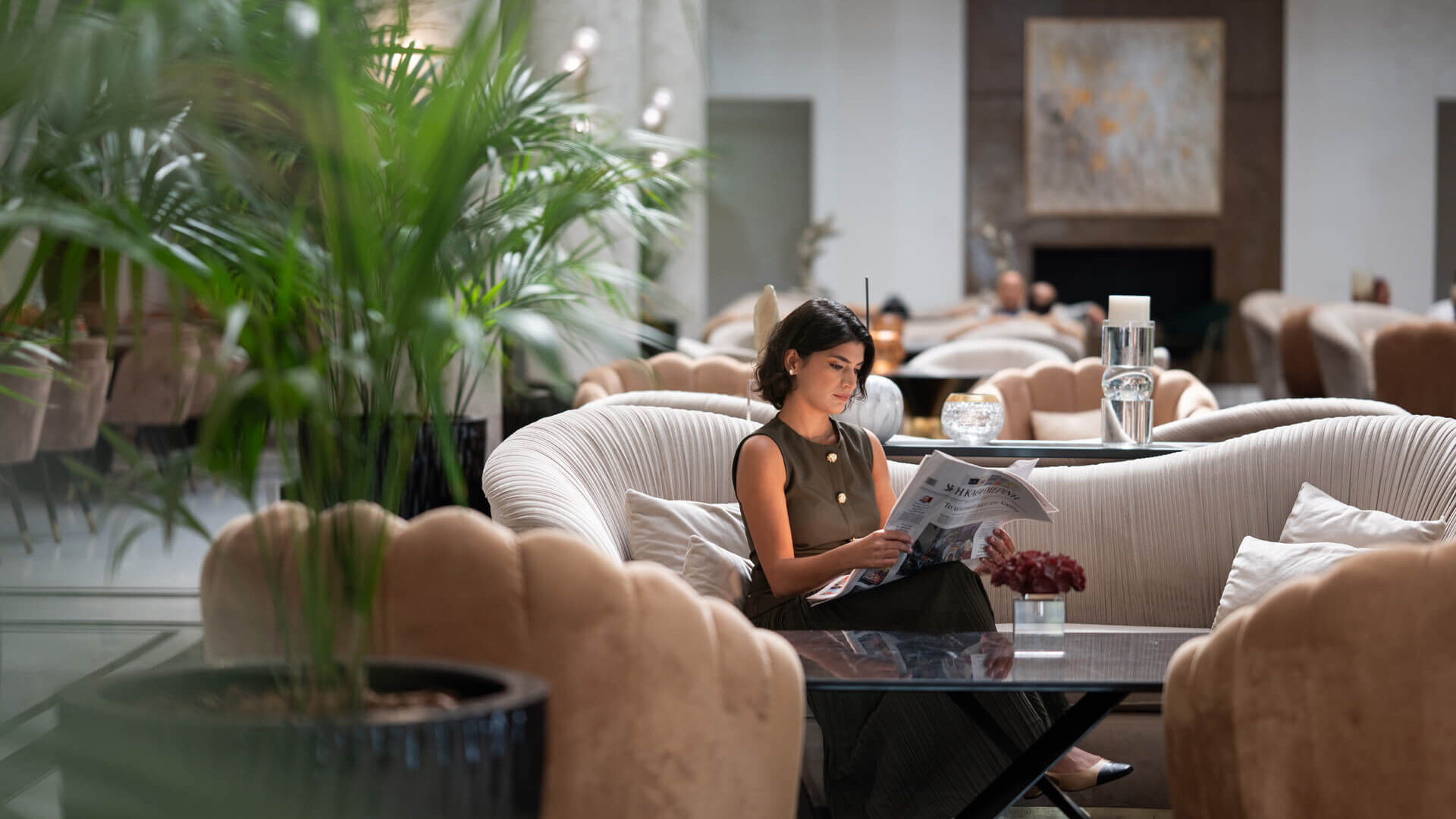 Woman reading magazine at reception of Hilton Nicosia