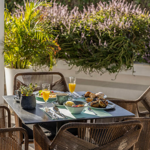Table with breakfast at outdoor space at Hilton Nicosia