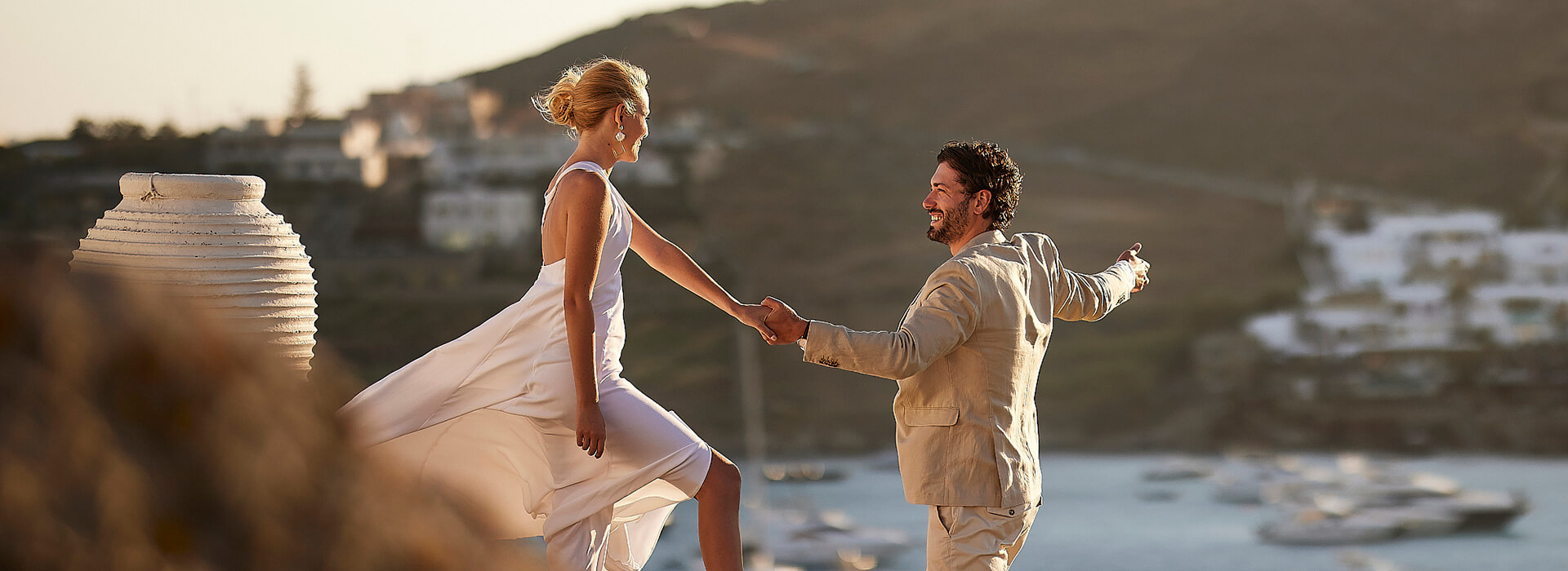Bride and groom enjoying a romantic seaside wedding celebration at sunset
