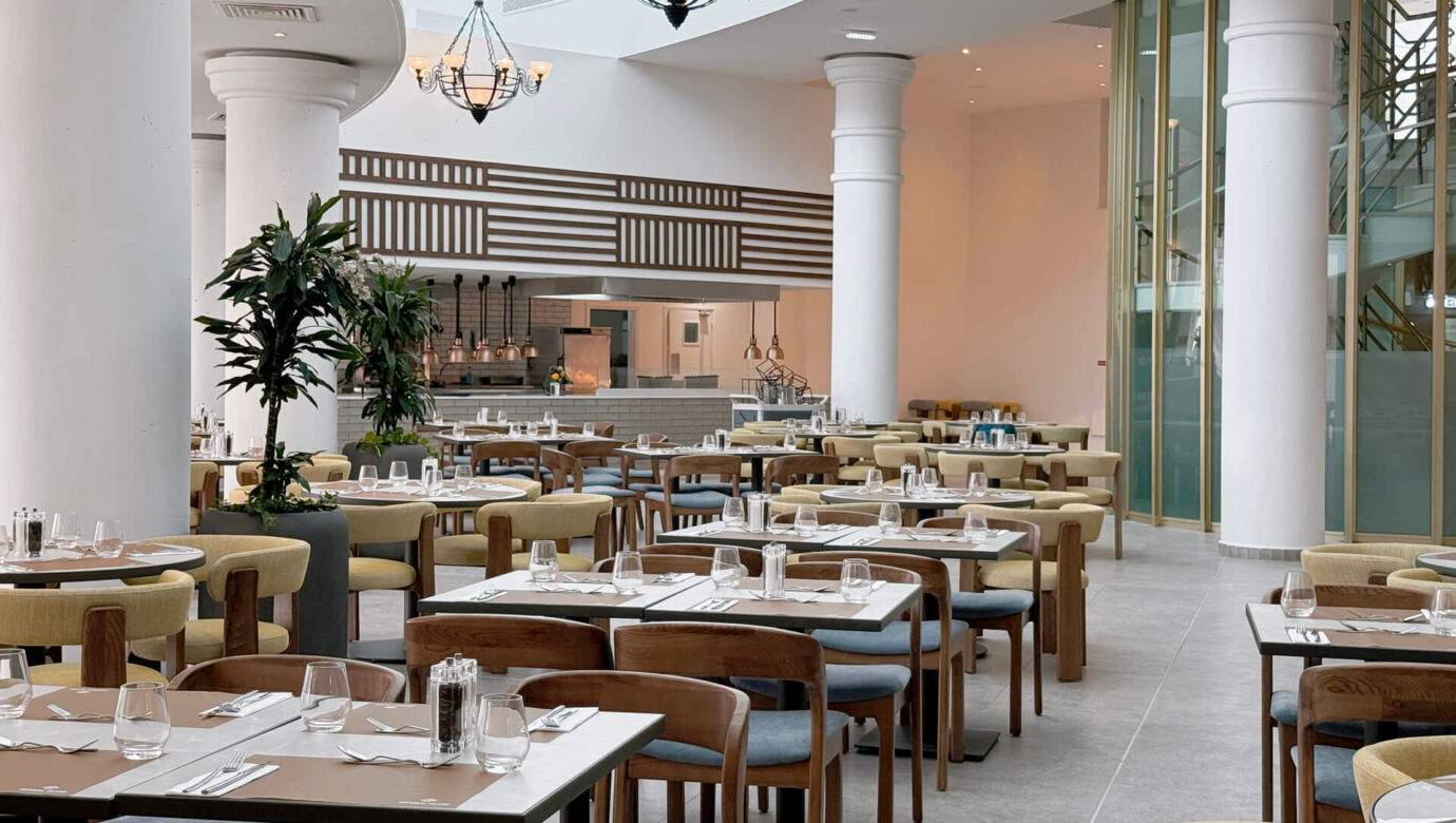 Main restaurant tables and kitchen at Imperial Island Resort
