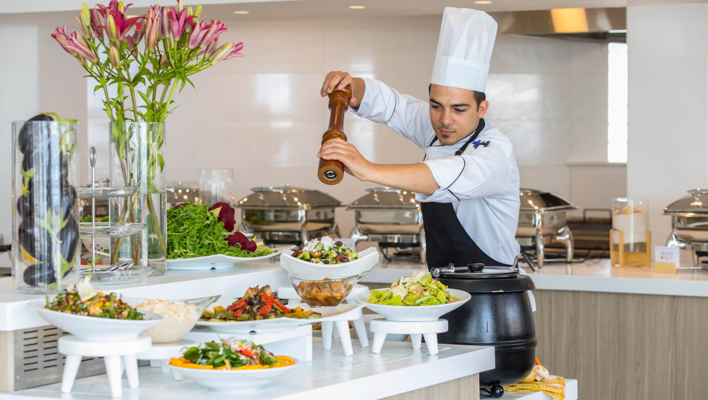 Chef preparing salad at Infinity Blu buffet