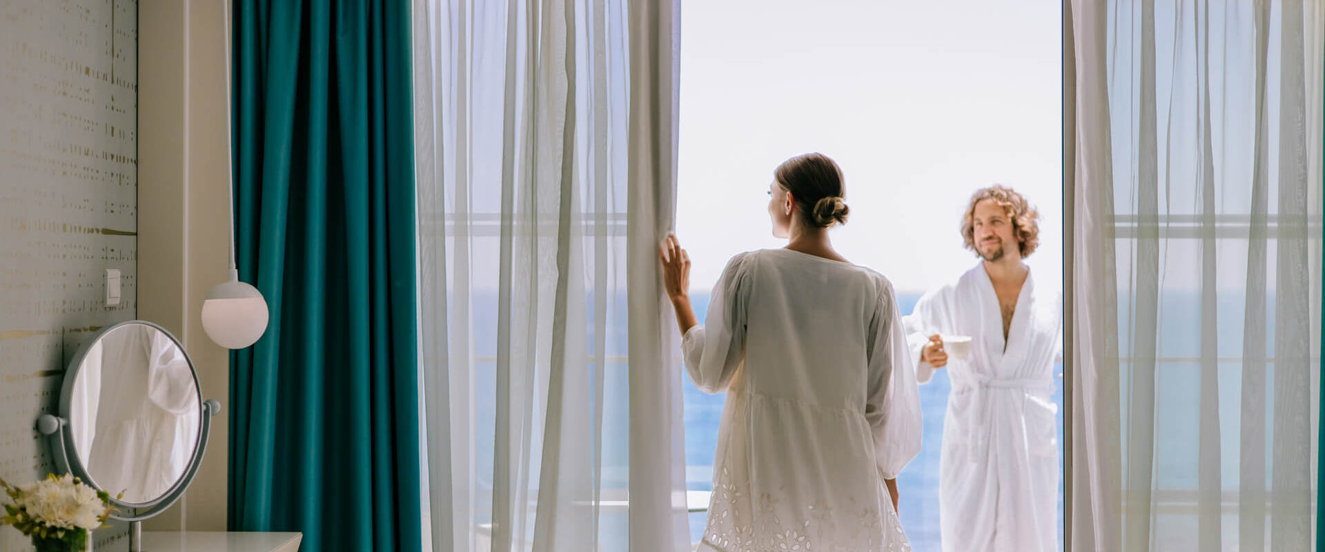 Couple relaxing in robes wathing the sea at Ivi mare