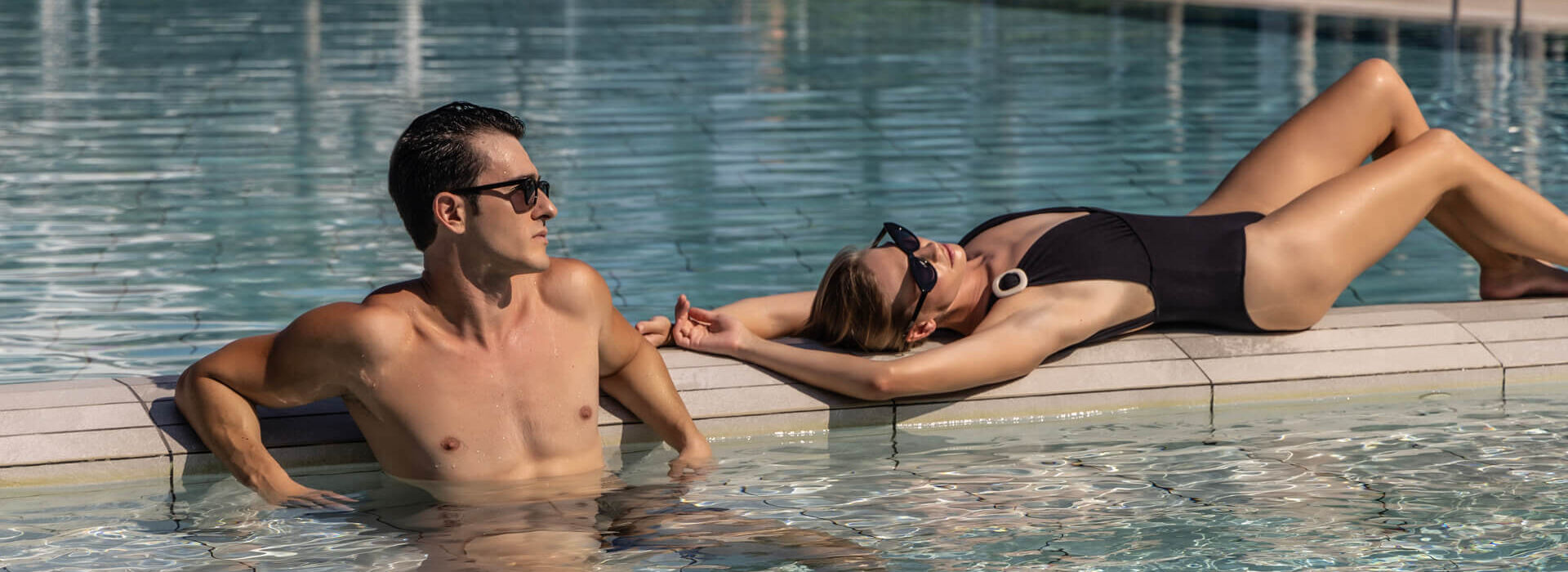 Couple relaxing inside pool of Ivi Mare