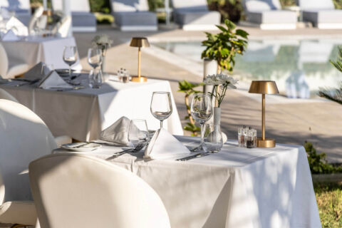 Table prepared for dinner with wine glasses at Ivi Mare