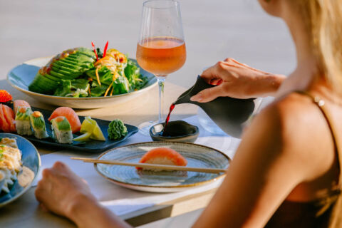 Woman serving soya to eat asian dishes