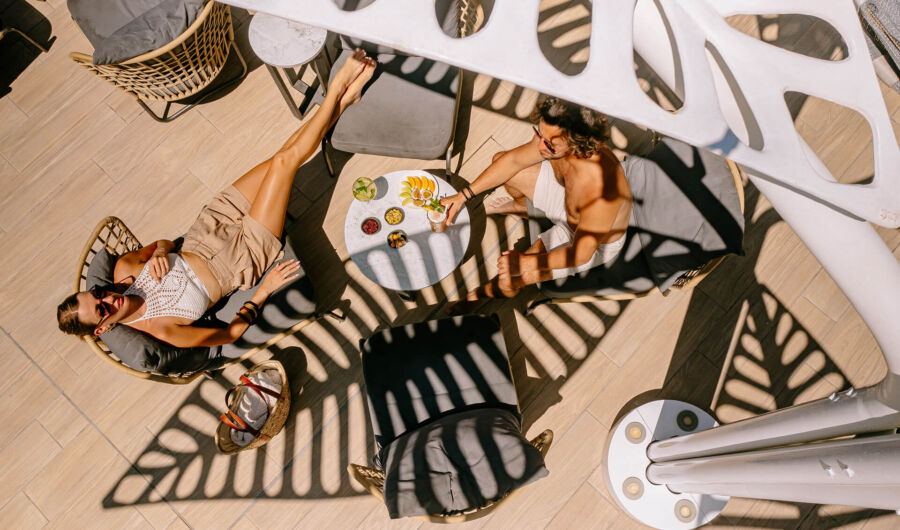 Couple lying under shade in ivi mare patio
