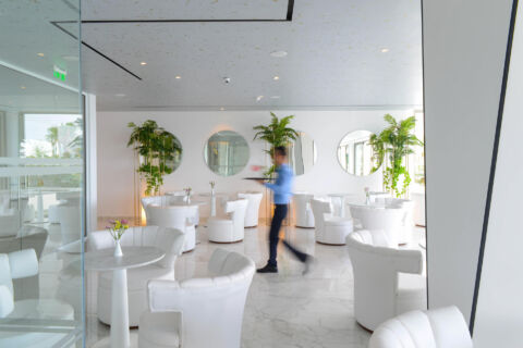 Waiter walking through indoors restaurant at ivi Mare
