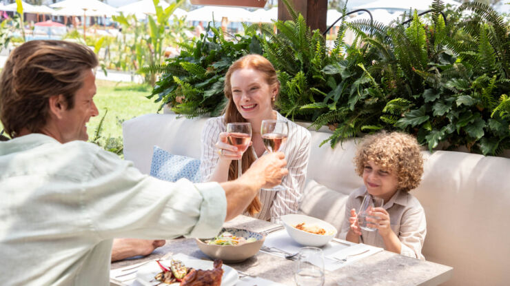 Family eating lunch outdoors at Kerkyra Blue Hotel restaurant