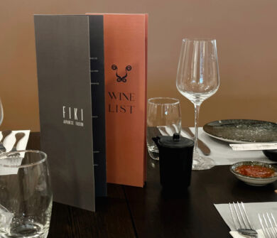 Menus and table prepared for dinner at Kerkyra Blue Fiki restaurant