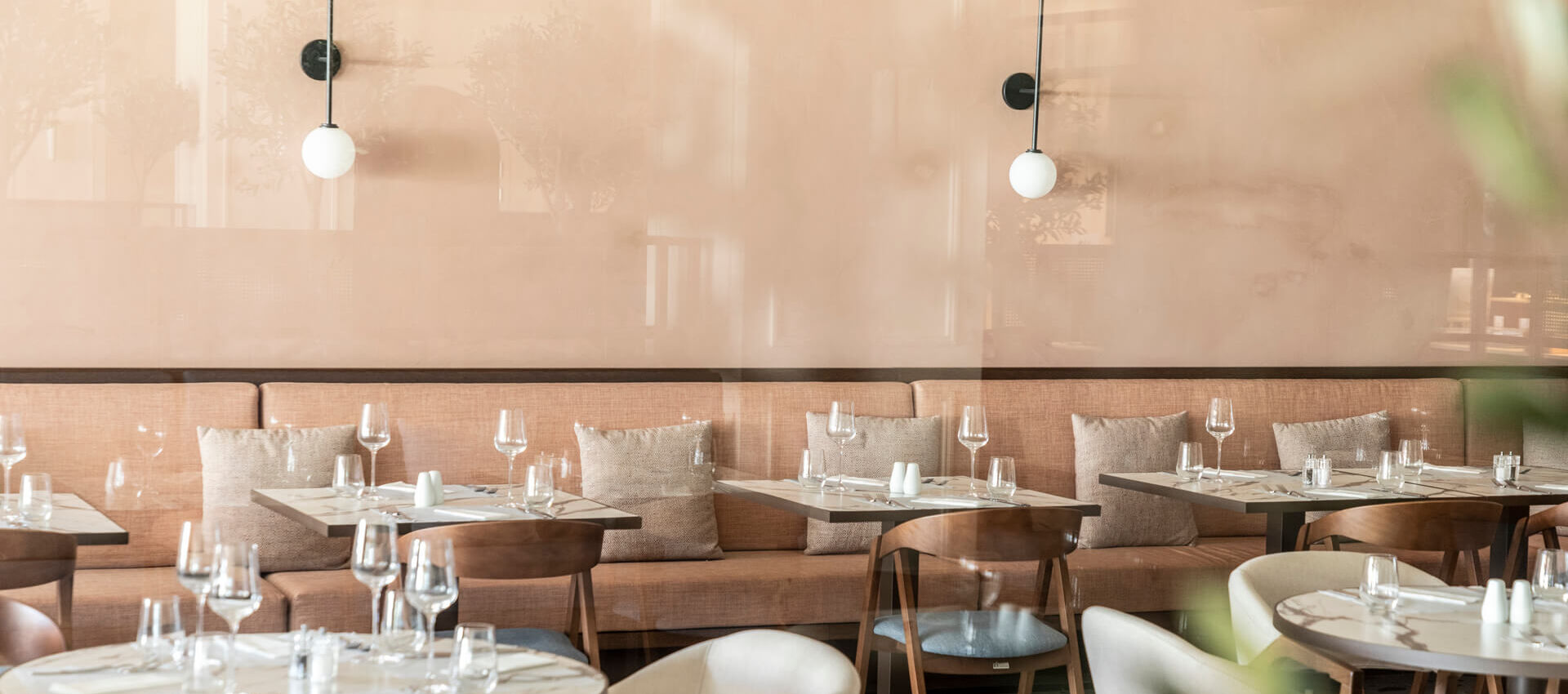 Indoor tables prepared for lunch at Kerkyra Blue Naida restaurant
