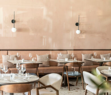 Indoor tables prepared for lunch at Kerkyra Blue Naida restaurant
