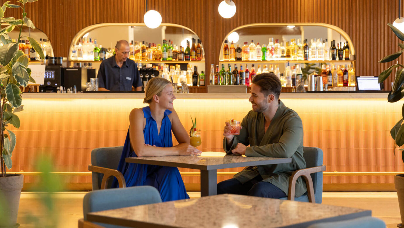 Couple drinking cocktails and smiling at Kerkyra Blue bar