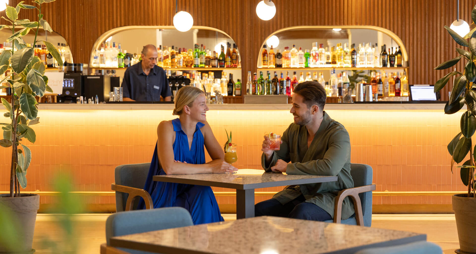 Couple drinking cocktails and smiling at Kerkyra Blue bar