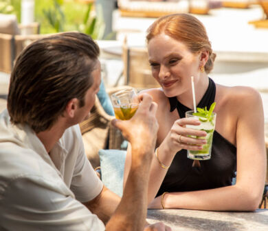 Couple drinking cocktails and smiling at Kerkyra Blue bar
