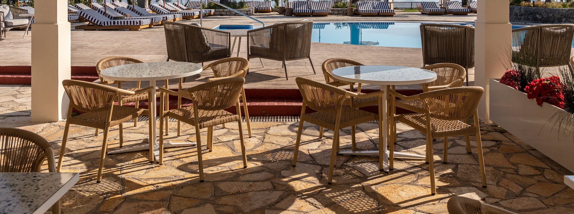 Outdoor table near pool at Kerkyra Blue