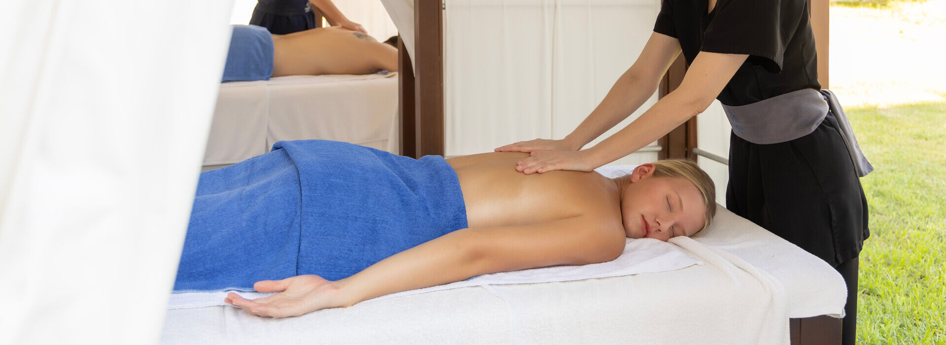 Woman getting a massage outdoors at Kerkyra Blue spa