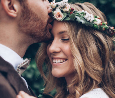 Man kissing bride on the forehead