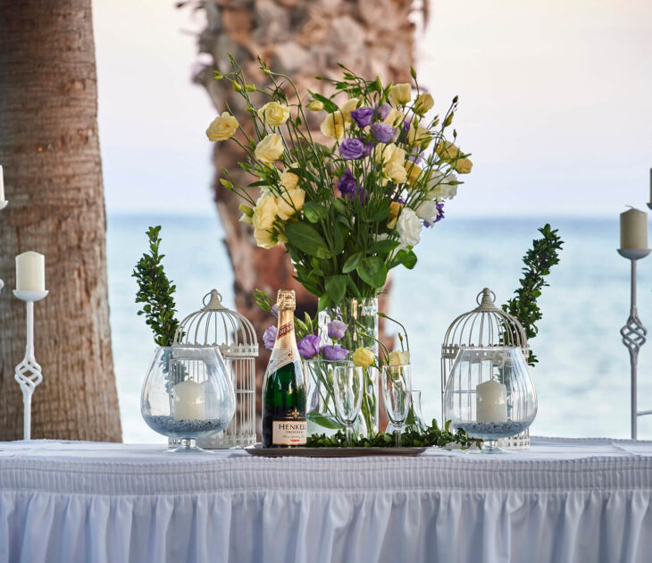 Table with wine and wedding decorations at Kerkyra Blue