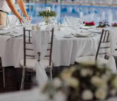 Waiter preparing table pool side at Kerkyra Blue