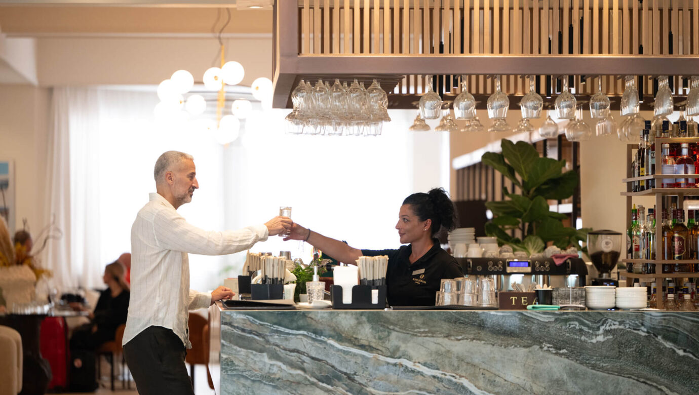 Man getting water from Barwoman at King Jason Paphos bar