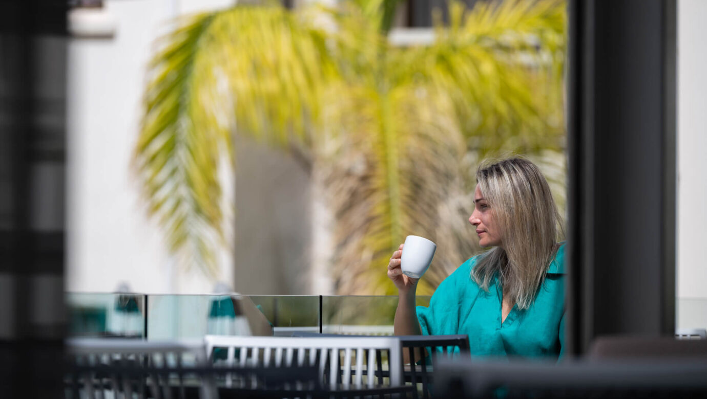 Woman Drinking coffee at King Jason Paphos