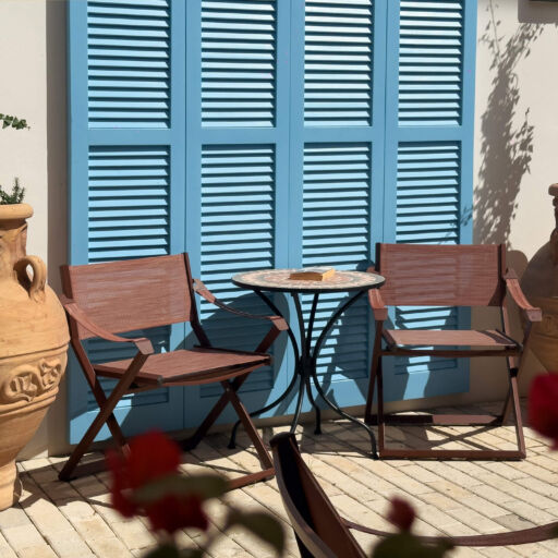 King Jason Paphos blue window with table and chairs
