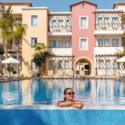Woman swimming at the pool of Louis Althea Hotel