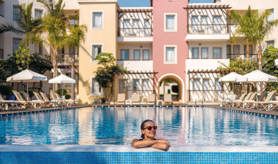 Woman swimming at the pool of Louis Althea Hotel