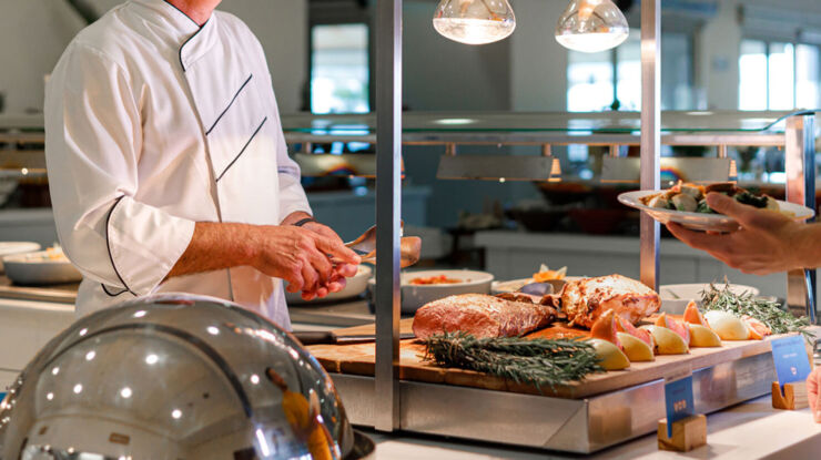 Chef serving food at Louis Althea restaurant
