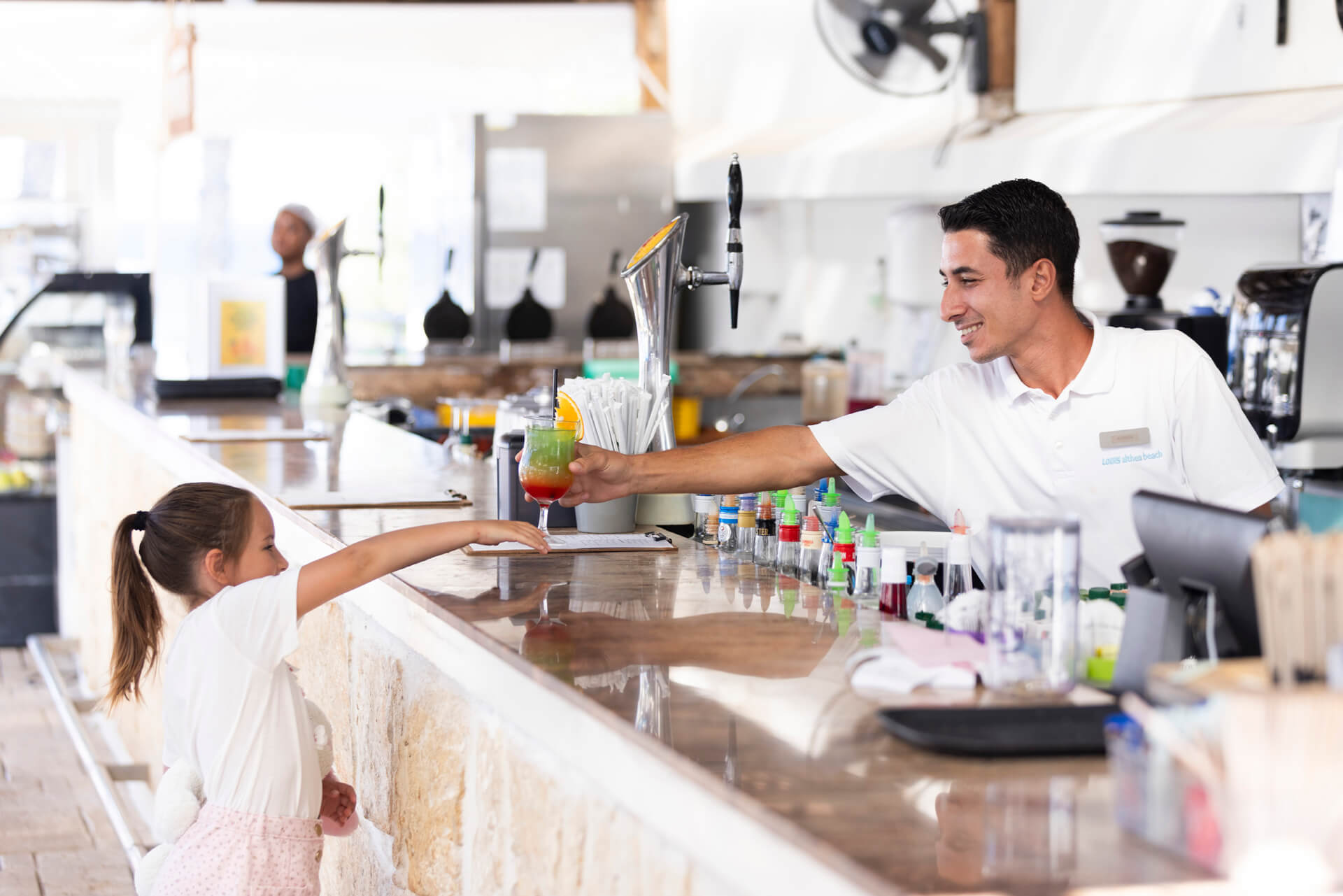 Kid getting a drink at Louis Althea dionysos bar