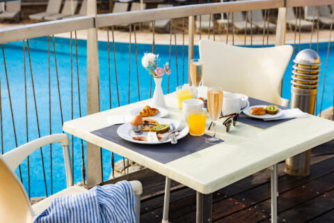 Table with food near the pool at Louis Althea